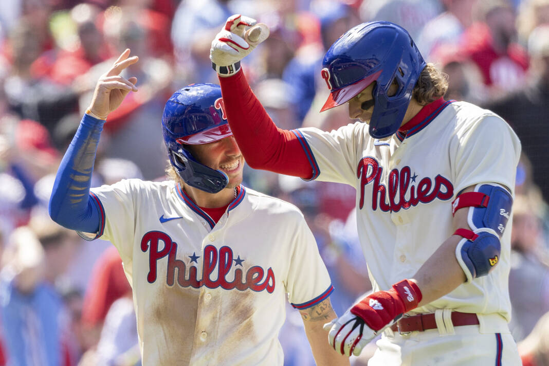 Philadelphia Phillies' Edmundo Sosa reacts after scoring during