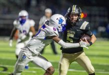 Perrysburg senior quarterback Josh Takats (5) fights off a Springfield tackler. (Kenneth Falls Photography)